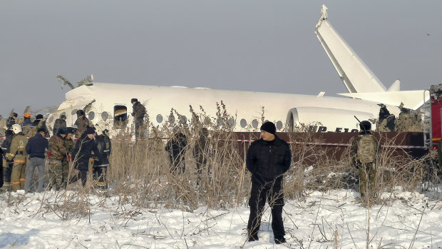 Rescuers attend the scene of the plane crash near Almaty International Airport, Kazakhstan.