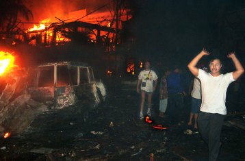 Residents and tourists at the scene of the Bali terrorist attacks of 2002.