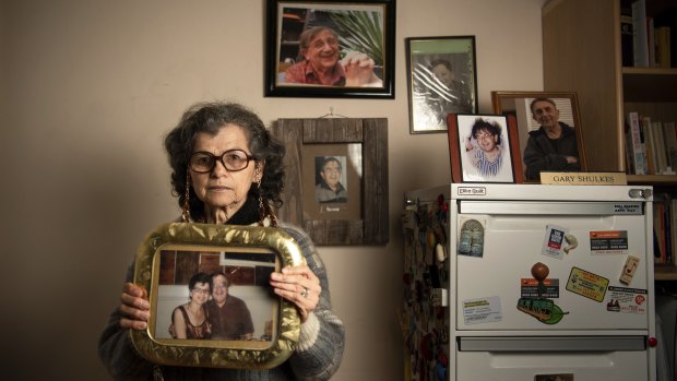Widow Golda Shulkes with photos of her late husband Gary.