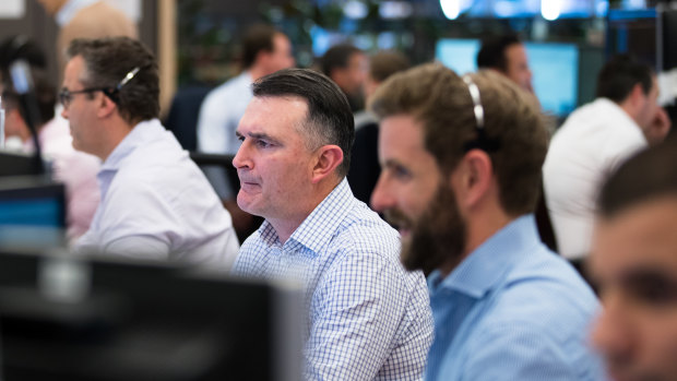 Traders on the UBS trading floor during the RBA's interest rate cut, in Sydney. 2nd July 2019 Photo: Janie Barrett