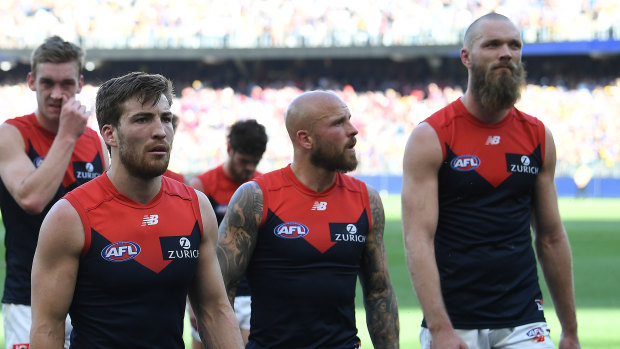 Jack Viney, Nathan Jones and Max Gawn lead the Demons off the field after their preliminary final loss to West Coast