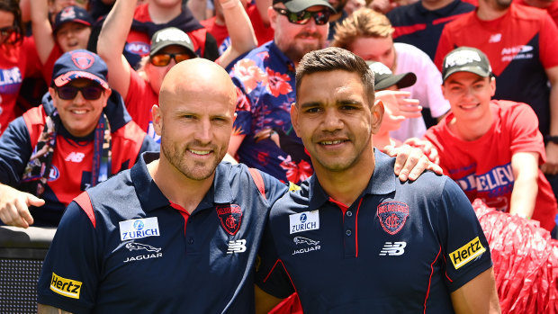 Nathan Jones and Neville Jetta celebrate with the Demons faithful at the MCG last December.