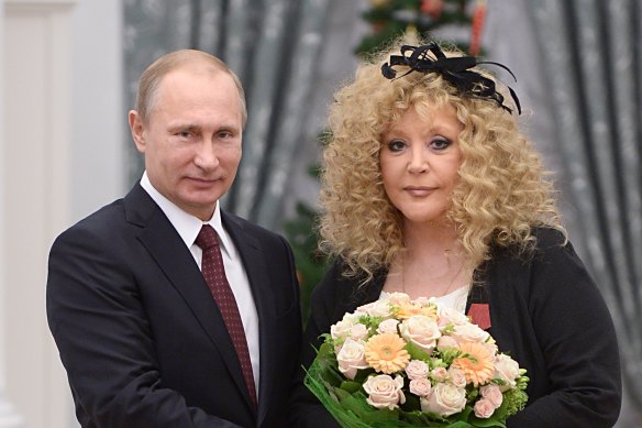 Vladimir Putin and Russian pop singer Alla Pugacheva pose for a photo during an awards ceremony at the Kremlin in 2014.