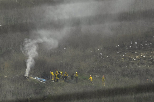 Firefighters work at the scene of the helicopter crash that killed former NBA star Kobe Bryant, his daughter and seven others.