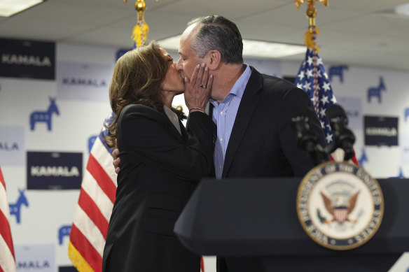 Vice President Kamala Harris, left, kisses second gentleman Doug Emhoff as she addresses staff at Harris HQ in Delaware