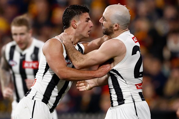 Nick Daicos (left) and Steele Sidebottom celebrate a goal.