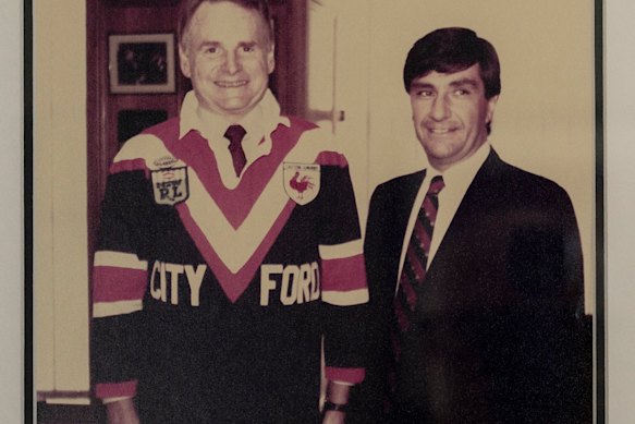 Politis (right) with Ford global president Harold “Red” Poling in a Roosters jersey in the 1970s. 
