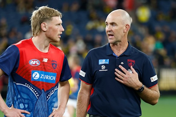 Steven King (right) has a chat with young Demons ruckman Max Heath.