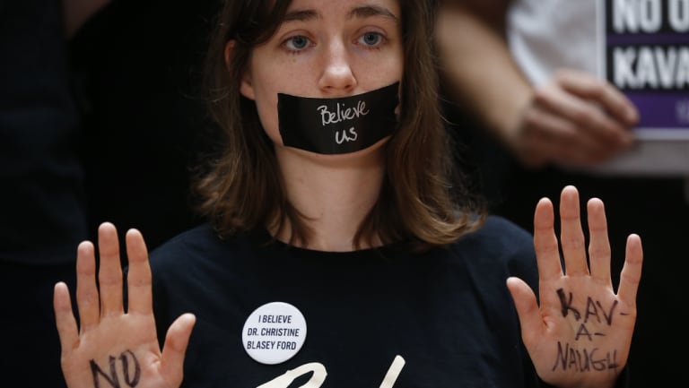 A protester displays a note on her hand that reads "No Kavanaugh" while demonstrating ahead of a Senate Judiciary Committee hearing in Washington, D.C. on Thursday, September 27, 2018.