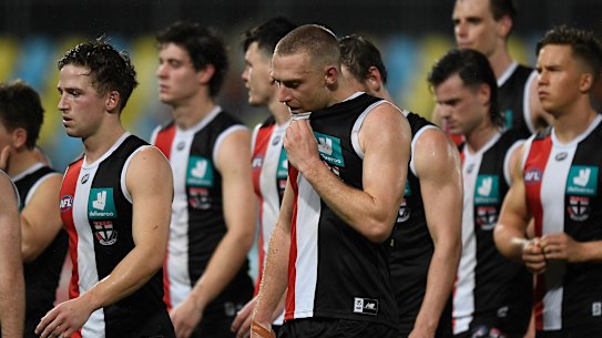 The Saints walk from the field after giving up a commanding lead against Adelaide.