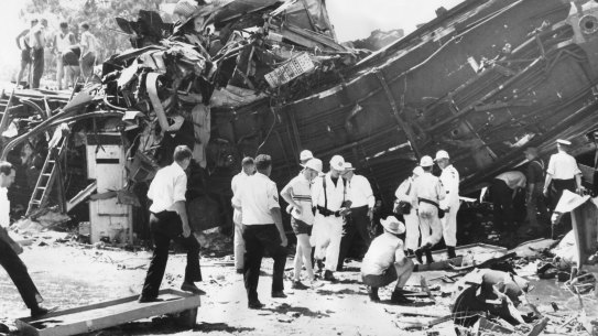 Rescue workers searching the tangled wreckage of the two trains.