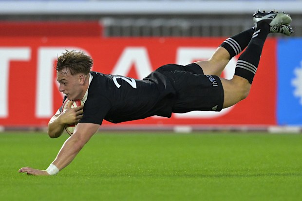 Ruben Love of New Zealand scores a try.
