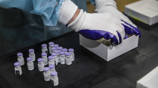 A worker at Monash Medical Centre retrieves vials of the Pfizer vaccine from the freezer on Wednesday.