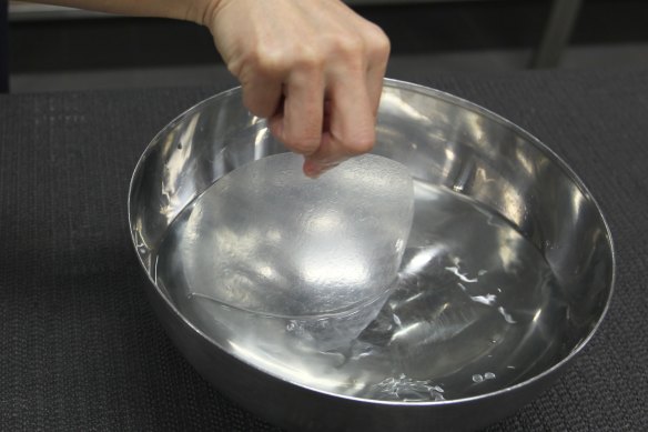 Briefly dip one side of the rice paper roll into a bowl of water, rotating it to moisten the wrapper.