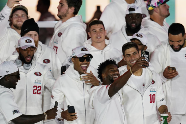 San Francisco 49ers take selfies after arriving in Miami ahead of the Super Bowl.