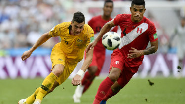 Australia just can't seem to win:  Australia's Tomi Juric, left, and Peru's Anderson Santamaria challenge for the ball.