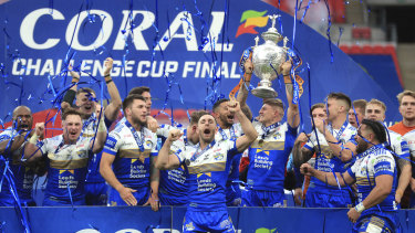 Leeds Rhinos celebrate with the trophy after the Challenge Cup Final at Wembley Stadium, in London, Saturday, Oct. 17, 2020. Leeds Rhinos won English rugby league’s Challenge Cup for the 14th time by beating Salford Red Devils 17-16 thanks to a drop goal five minutes from the time at a deserted Wembley Stadium. 