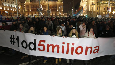 People hold a banner that reads: "#1 Out of 5 million" during a protest against populist President Aleksandar Vucic in Belgrade on Saturday.