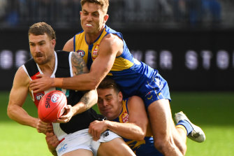 Dean Kent is tackled by Brad Sheppard.