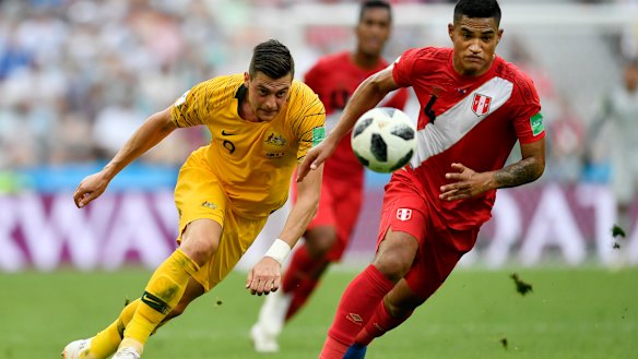 Australia just can't seem to win:  Australia's Tomi Juric, left, and Peru's Anderson Santamaria challenge for the ball.