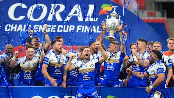 Leeds Rhinos celebrate with the trophy after the Challenge Cup Final at Wembley Stadium, in London, Saturday, Oct. 17, 2020. Leeds Rhinos won English rugby league’s Challenge Cup for the 14th time by beating Salford Red Devils 17-16 thanks to a drop goal five minutes from the time at a deserted Wembley Stadium. 
