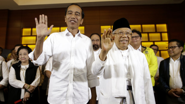 Triumphant: Indonesian President Joko Widodo, and his running mate Maruf Amin. 