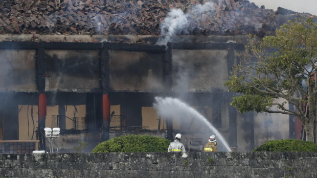 Firefighters try to extinguish a fire at the north hall of Shuri Castle on Thursday.