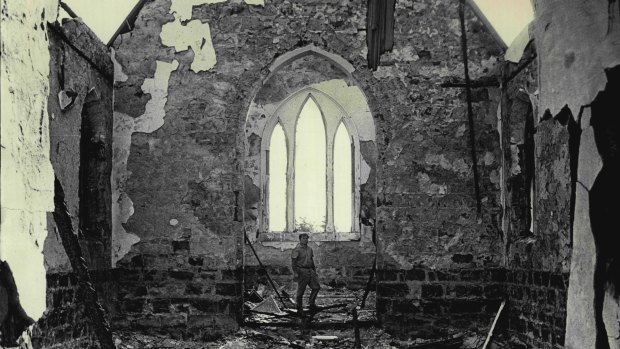 Vicar Fred Dearnaley stands in the ruins of Lara's Holy Trinity Church of England.