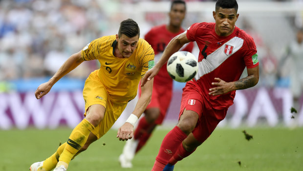 Australia just can't seem to win:  Australia's Tomi Juric, left, and Peru's Anderson Santamaria challenge for the ball.
