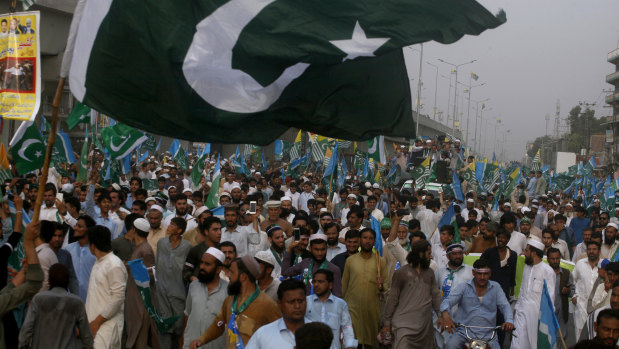 Supporters of the religious group Jamaat-e-Islami participate in a rally to express solidarity with Indian Kashmiris in Peshawar, Pakistan, on Sunday.