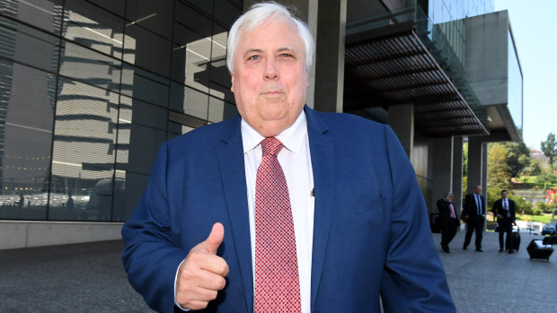 Clive Palmer gestures as he leaves the Supreme Court in Brisbane.