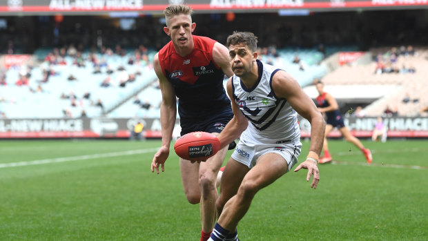 Hamstrung: Fremantle's Stephen Hill in action against Sam Frost of the Demons at the MCG during round 14.