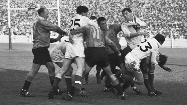A fight breaks out during the Rugby League tour match between England and NSW. Players from left to right, are Billy Wilson (NSW), 
Derek Turner (England, No. 25), Robin Gourley (NSW, No. 11), Barry Harris (NSW), Brian Edgar 
(England), Mike Sullivan (England) and Brian Hambly (NSW), who is being held by Sullivan.
