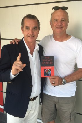Bradley Charles Stubbs poses with his first book, The Science of Belief with Socceroos coach Graham Arnold.