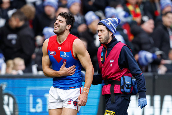 Christian Petracca leaves the field with suspected broken ribs.