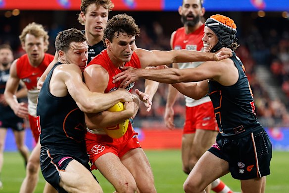 Toby Greene tackles Swans opponent Sam Wicks.