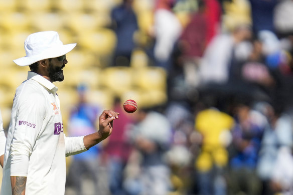India’s Ravindra Jadeja is given the ball after getting five wickets as he walks back during the first day of the first cricket test match against Australia.