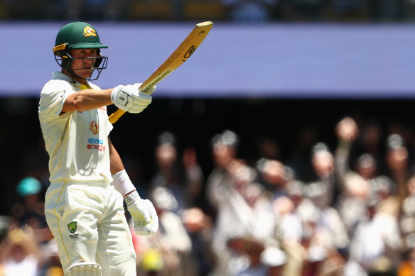 Marnus Labuschagne raises his bat after making a half century.