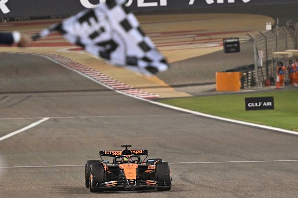 Australia’s Oscar Piastri takes the chequered flag in Bahrain.