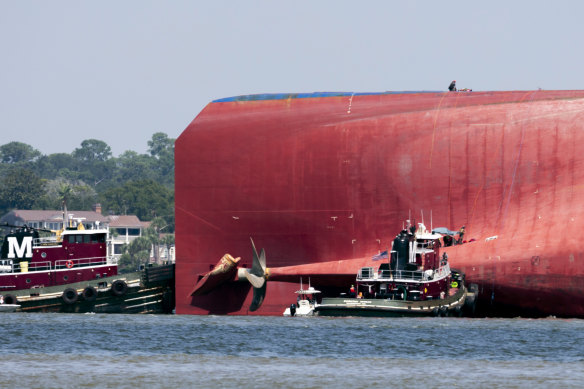 Rescuers rappelled down the side of the ship and made contact with four crew members trapped inside.