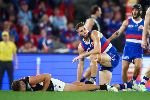 Dan Houston of the Power lays on the ground after colliding with Marcus Bontempelli.