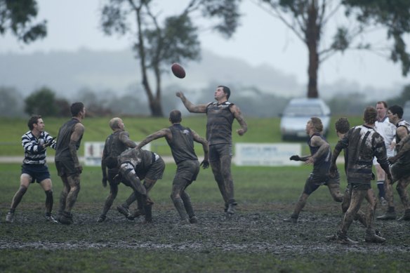 Fans watch the West Gippsland La Trobe Football League from cars in 2004.  
