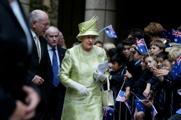 Queen Elizabeth greets students from St Andrews School on a visit to Australia for the 2006 Commonwealth Games.