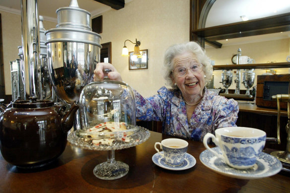 Margaret Barton, who starred in the 1945 movie Brief Encounter stands in the refurbished refreshment bar at Carnforth train station, 2003.