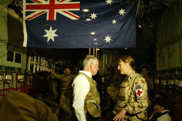 John Howard in a flak jacket prepares for the Anzac Day dawn ceremony in Baghdad, 2004. 