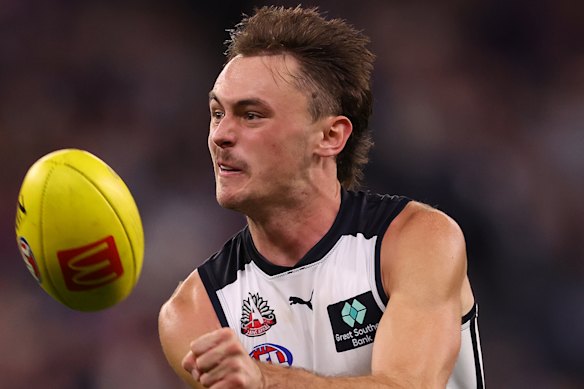Matthew Carroll of the Blues handballs.