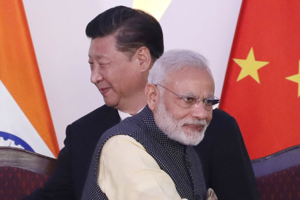  Indian Prime Minister Narendra Modi, front and Chinese President Xi Jinping at the BRICS summit in Goa, India, in 2016. 