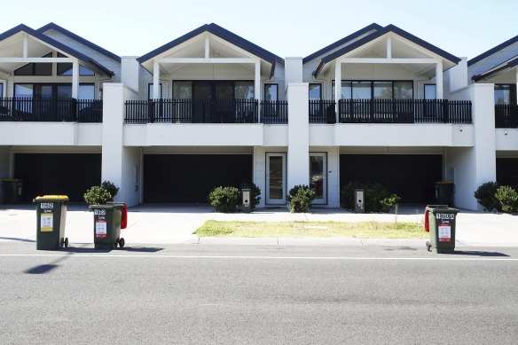 A row of townhouses in Craigieburn that were built to comply with the small-lot housing code and have no space for substantial trees.