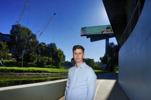 Resident Adrian Jackson at Moonee Ponds Creek, with the Macaulay apartment construction behind him.