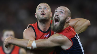 Tap and go: Essendon's Tom Bellchambers goes up in a ruck contest against Melbourne big man Max Gawn.